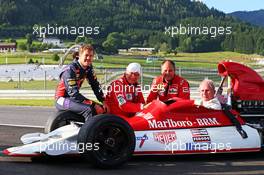 Dr Helmut Marko (AUT) Red Bull Motorsport Consultant, sitting in his old BRM P160, with (L to R): Sebastian Vettel (GER) Red Bull Racing; Niki Lauda (AUT) Mercedes Non-Executive Chairman; and Gerhard Berger (AUT). 21.06.2014. Formula 1 World Championship, Rd 8, Austrian Grand Prix, Spielberg, Austria, Qualifying Day.