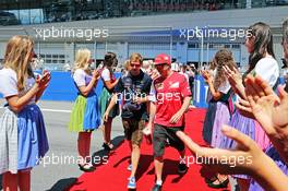 (L to R): Sebastian Vettel (GER) Red Bull Racing with Kimi Raikkonen (FIN) Ferrari on the drivers parade. 22.06.2014. Formula 1 World Championship, Rd 8, Austrian Grand Prix, Spielberg, Austria, Race Day.