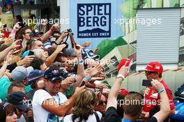Kimi Raikkonen (FIN) Ferrari signs autographs for the fans. 19.06.2014. Formula 1 World Championship, Rd 8, Austrian Grand Prix, Spielberg, Austria, Preparation Day.