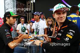 (L to R): Sergio Perez (MEX) Sahara Force India F1 and team mate Nico Hulkenberg (GER) Sahara Force India F1 sign autographs for the fans. 19.06.2014. Formula 1 World Championship, Rd 8, Austrian Grand Prix, Spielberg, Austria, Preparation Day.