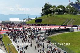 The fans stream down the start/finish straight. 19.06.2014. Formula 1 World Championship, Rd 8, Austrian Grand Prix, Spielberg, Austria, Preparation Day.