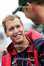 (L to R): Sebastian Vettel (GER) Red Bull Racing with Andre Lotterer (GER) Caterham F1 Team. 22.08.2014. Formula 1 World Championship, Rd 12, Belgian Grand Prix, Spa Francorchamps, Belgium, Practice Day.