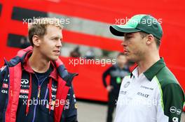(L to R): Sebastian Vettel (GER) Red Bull Racing with Andre Lotterer (GER) Caterham F1 Team. 22.08.2014. Formula 1 World Championship, Rd 12, Belgian Grand Prix, Spa Francorchamps, Belgium, Practice Day.