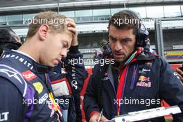 (L to R): Sebastian Vettel (GER) Red Bull Racing with Guillaume Rocquelin (ITA) Red Bull Racing Race Engineer on the grid. 24.08.2014. Formula 1 World Championship, Rd 12, Belgian Grand Prix, Spa Francorchamps, Belgium, Race Day.