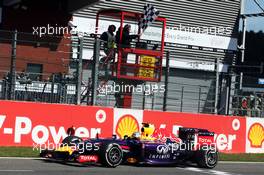 Race winner Daniel Ricciardo (AUS) Red Bull Racing RB10 celebrates as he takes the chequered flag at the end of the race. 24.08.2014. Formula 1 World Championship, Rd 12, Belgian Grand Prix, Spa Francorchamps, Belgium, Race Day.