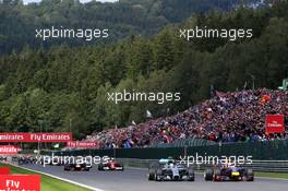Lewis Hamilton (GBR) Mercedes AMG F1 W05 and Sebastian Vettel (GER) Red Bull Racing RB10 battle the lead at the start of the race. 24.08.2014. Formula 1 World Championship, Rd 12, Belgian Grand Prix, Spa Francorchamps, Belgium, Race Day.