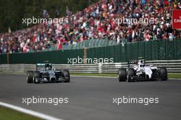 (L to R): Nico Rosberg (GER) Mercedes AMG F1 W05 and Valtteri Bottas (FIN) Williams FW36 battle for position. 24.08.2014. Formula 1 World Championship, Rd 12, Belgian Grand Prix, Spa Francorchamps, Belgium, Race Day.