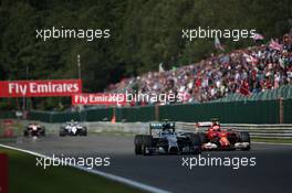 Nico Rosberg (GER) Mercedes AMG F1 W05 and Kimi Raikkonen (FIN) Ferrari F14-T battle for position. 24.08.2014. Formula 1 World Championship, Rd 12, Belgian Grand Prix, Spa Francorchamps, Belgium, Race Day.
