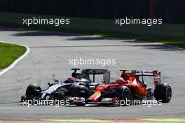 Kimi Raikkonen (FIN) Ferrari F14-T and Jenson Button (GBR) McLaren MP4-29 battle for position. 24.08.2014. Formula 1 World Championship, Rd 12, Belgian Grand Prix, Spa Francorchamps, Belgium, Race Day.