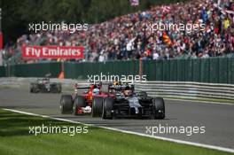 Kevin Magnussen (DEN) McLaren MP4-29 and Fernando Alonso (ESP) Ferrari F14-T battle for position. 24.08.2014. Formula 1 World Championship, Rd 12, Belgian Grand Prix, Spa Francorchamps, Belgium, Race Day.
