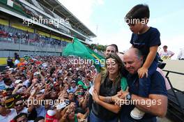 Rafaela Bassi (BRA), with son Felipinho Massa (BRA) and Luis Antonio Massa (BRA), father of Felipe Massa (BRA) Williams, at the end of the race. 09.11.2014. Formula 1 World Championship, Rd 18, Brazilian Grand Prix, Sao Paulo, Brazil, Race Day.