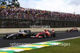 Jenson Button (GBR) McLaren MP4-29 and Kimi Raikkonen (FIN). 09.11.2014. Formula 1 World Championship, Rd 18, Brazilian Grand Prix, Sao Paulo, Brazil, Race Day.