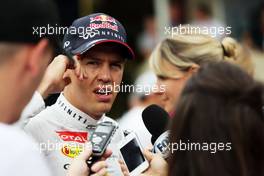 Sebastian Vettel (GER) Red Bull Racing with the media. 08.11.2014. Formula 1 World Championship, Rd 18, Brazilian Grand Prix, Sao Paulo, Brazil, Qualifying Day.