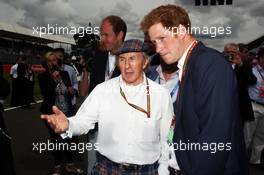 (L to R): Jackie Stewart (GBR) with HRH Prince Harry (GBR) on the grid. 06.07.2014. Formula 1 World Championship, Rd 9, British Grand Prix, Silverstone, England, Race Day.