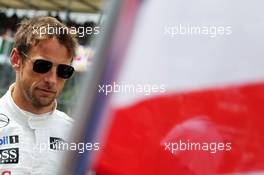 Jenson Button (GBR) McLaren on the grid. 06.07.2014. Formula 1 World Championship, Rd 9, British Grand Prix, Silverstone, England, Race Day.