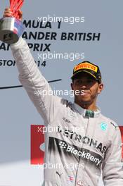 Race winner Lewis Hamilton (GBR) Mercedes AMG F1 celebrates on the podium. 06.07.2014. Formula 1 World Championship, Rd 9, British Grand Prix, Silverstone, England, Race Day.