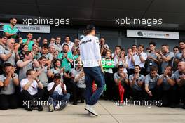 Nico Rosberg (GER) Mercedes AMG F1 comes to celebrate victory for team mate Lewis Hamilton (GBR) Mercedes AMG F1 with the team. 06.07.2014. Formula 1 World Championship, Rd 9, British Grand Prix, Silverstone, England, Race Day.