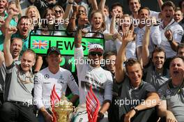 Race winner Lewis Hamilton (GBR) Mercedes AMG F1 celebrates with team mate Nico Rosberg (GER) Mercedes AMG F1 and the team. 06.07.2014. Formula 1 World Championship, Rd 9, British Grand Prix, Silverstone, England, Race Day.
