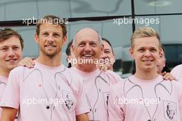(L to R): Jenson Button (GBR) McLaren; Ron Dennis (GBR) McLaren Executive Chairman; Kevin Magnussen (DEN) McLaren; and the McLaren team wear Pink for Papa, in tribute to the late John Button (GBR). 06.07.2014. Formula 1 World Championship, Rd 9, British Grand Prix, Silverstone, England, Race Day.