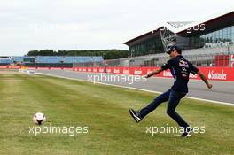 Daniel Ricciardo (AUS) Red Bull Racing takes a penalty kick. 03.07.2014. Formula 1 World Championship, Rd 9, British Grand Prix, Silverstone, England, Preparation Day.