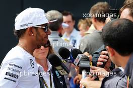 Lewis Hamilton (GBR) Mercedes AMG F1 with the media. 03.07.2014. Formula 1 World Championship, Rd 9, British Grand Prix, Silverstone, England, Preparation Day.