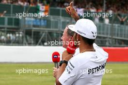 Lewis Hamilton (GBR) Mercedes AMG F1 acnowledges the fans. 03.07.2014. Formula 1 World Championship, Rd 9, British Grand Prix, Silverstone, England, Preparation Day.