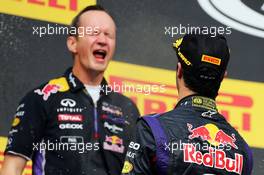 Race winner Daniel Ricciardo (AUS) Red Bull Racing celebrates with the champagne with Paul Monaghan (GBR) Red Bull Racing Chief Engineer on the podium. 27.07.2014. Formula 1 World Championship, Rd 11, Hungarian Grand Prix, Budapest, Hungary, Race Day.