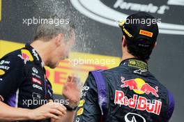 Race winner Daniel Ricciardo (AUS) Red Bull Racing celebrates with the champagne with Paul Monaghan (GBR) Red Bull Racing Chief Engineer on the podium. 27.07.2014. Formula 1 World Championship, Rd 11, Hungarian Grand Prix, Budapest, Hungary, Race Day.