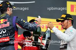 (L to R): Race winner Lewis Hamilton (GBR) Mercedes AMG F1 and third placed Lewis Hamilton (GBR) Mercedes AMG F1 celebrate with the champagne on the podium. 27.07.2014. Formula 1 World Championship, Rd 11, Hungarian Grand Prix, Budapest, Hungary, Race Day.