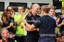Sebastian Vettel (GER) Red Bull Racing talks with Adrian Newey (GBR) Red Bull Racing Chief Technical Officer as the team celebrate victory for Daniel Ricciardo (AUS) Red Bull Racing. 27.07.2014. Formula 1 World Championship, Rd 11, Hungarian Grand Prix, Budapest, Hungary, Race Day.