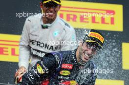 Race winner Daniel Ricciardo (AUS) Red Bull Racing celebrates with Lewis Hamilton (GBR) Mercedes AMG F1 and the champagne on the podium. 27.07.2014. Formula 1 World Championship, Rd 11, Hungarian Grand Prix, Budapest, Hungary, Race Day.