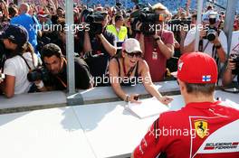 Kimi Raikkonen (FIN) Ferrari signs autographs for the fans. 24.07.2014. Formula 1 World Championship, Rd 11, Hungarian Grand Prix, Budapest, Hungary, Preparation Day.