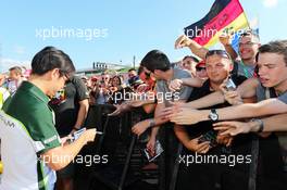 Kamui Kobayashi (JPN) Caterham signs autographs for the fans. 24.07.2014. Formula 1 World Championship, Rd 11, Hungarian Grand Prix, Budapest, Hungary, Preparation Day.