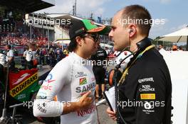 Sergio Perez (MEX) Sahara Force India F1 with Gianpiero Lambiase (ITA) Sahara Force India F1 Engineer on the grid. 07.09.2014. Formula 1 World Championship, Rd 13, Italian Grand Prix, Monza, Italy, Race Day.