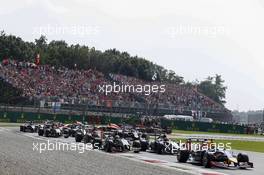Sergio Perez (MEX) Sahara Force India F1 VJM07 and Jenson Button (GBR) McLaren MP4-29 at the start of the race. 07.09.2014. Formula 1 World Championship, Rd 13, Italian Grand Prix, Monza, Italy, Race Day.
