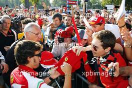 Fernando Alonso (ESP) Ferrari signs autographs for the fans. 06.09.2014. Formula 1 World Championship, Rd 13, Italian Grand Prix, Monza, Italy, Qualifying Day.