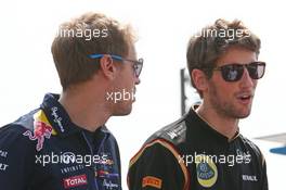 (L to R): Sebastian Vettel (GER) Red Bull Racing with Romain Grosjean (FRA) Lotus F1 Team on the drivers parade. 07.09.2014. Formula 1 World Championship, Rd 13, Italian Grand Prix, Monza, Italy, Race Day.