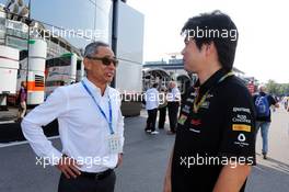 (L to R): Hiroshi Yasukawa (JPN) Dorna Sports Adviser with Jun Matsuzaki (JPN) Sahara Force India F1 Team Senior Tyre Engineer. 07.09.2014. Formula 1 World Championship, Rd 13, Italian Grand Prix, Monza, Italy, Race Day.