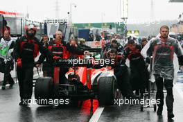 The Marussia F1 Team MR03 of Max Chilton (GBR) Marussia F1 Team is pushed back to parc ferme as the race is stopped. 05.10.2014. Formula 1 World Championship, Rd 15, Japanese Grand Prix, Suzuka, Japan, Race Day.