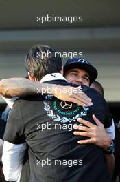 Lewis Hamilton (GBR) Mercedes AMG F1 celebrates winning the 2014 Constructors' Championship with Toto Wolff (GER) Mercedes AMG F1 Shareholder and Executive Director and the team. 12.10.2014. Formula 1 World Championship, Rd 16, Russian Grand Prix, Sochi Autodrom, Sochi, Russia, Race Day.