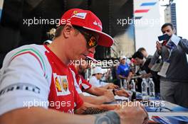 Kimi Raikkonen (FIN) Ferrari signs autographs for the fans. 09.10.2014. Formula 1 World Championship, Rd 16, Russian Grand Prix, Sochi Autodrom, Sochi, Russia, Preparation Day.