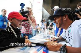 Lewis Hamilton (GBR) Mercedes AMG F1 signs autographs for the fans at the Fanzone. 09.10.2014. Formula 1 World Championship, Rd 16, Russian Grand Prix, Sochi Autodrom, Sochi, Russia, Preparation Day.
