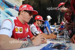 (L to R): Kimi Raikkonen (FIN) Ferrari and team mate Fernando Alonso (ESP) Ferrari sign autographs for the fans at the Fanzone. 09.10.2014. Formula 1 World Championship, Rd 16, Russian Grand Prix, Sochi Autodrom, Sochi, Russia, Preparation Day.