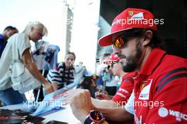 Fernando Alonso (ESP) Ferrari signs autographs for the fans at the Fanzone. 09.10.2014. Formula 1 World Championship, Rd 16, Russian Grand Prix, Sochi Autodrom, Sochi, Russia, Preparation Day.