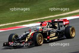 Charles Pic (FRA) Lotus F1 E22 Third Driver leaves the pits running new 18 inch Pirelli tyres and rims. 09.07.2014. Formula One Testing, Silverstone, England, Wednesday.