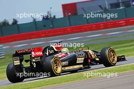 Charles Pic (FRA) Lotus F1 E22 Third Driver leaves the pits running new 18 inch Pirelli tyres and rims. 09.07.2014. Formula One Testing, Silverstone, England, Wednesday.