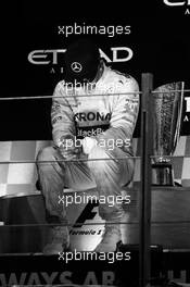 Race winner and World Champion Lewis Hamilton (GBR) Mercedes AMG F1 on the podium. 23.11.2014. Formula 1 World Championship, Rd 19, Abu Dhabi Grand Prix, Yas Marina Circuit, Abu Dhabi, Race Day.