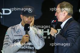 (L to R): race winner and World Champion Lewis Hamilton (GBR) Mercedes AMG F1 with Martin Brundle (GBR) Sky Sports Commentator on the podium. 23.11.2014. Formula 1 World Championship, Rd 19, Abu Dhabi Grand Prix, Yas Marina Circuit, Abu Dhabi, Race Day.