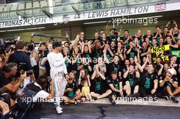Race winner and World Champion Lewis Hamilton (GBR) Mercedes AMG F1 celebrates with the team. 23.11.2014. Formula 1 World Championship, Rd 19, Abu Dhabi Grand Prix, Yas Marina Circuit, Abu Dhabi, Race Day.