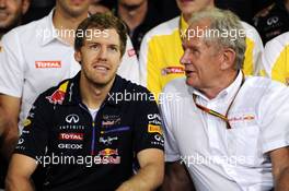 Dr Helmut Marko (AUT) Red Bull Motorsport Consultant (Right) and Red Bull Racing give thanks to the departing Sebastian Vettel (GER) Red Bull Racing. 23.11.2014. Formula 1 World Championship, Rd 19, Abu Dhabi Grand Prix, Yas Marina Circuit, Abu Dhabi, Race Day.